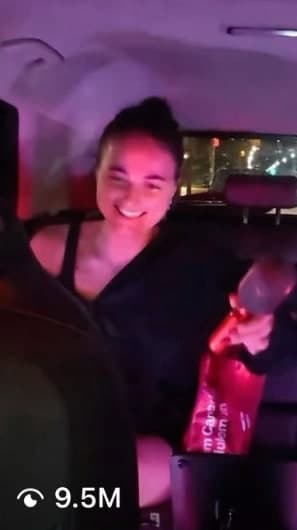 Passenger smiling under pink party lights